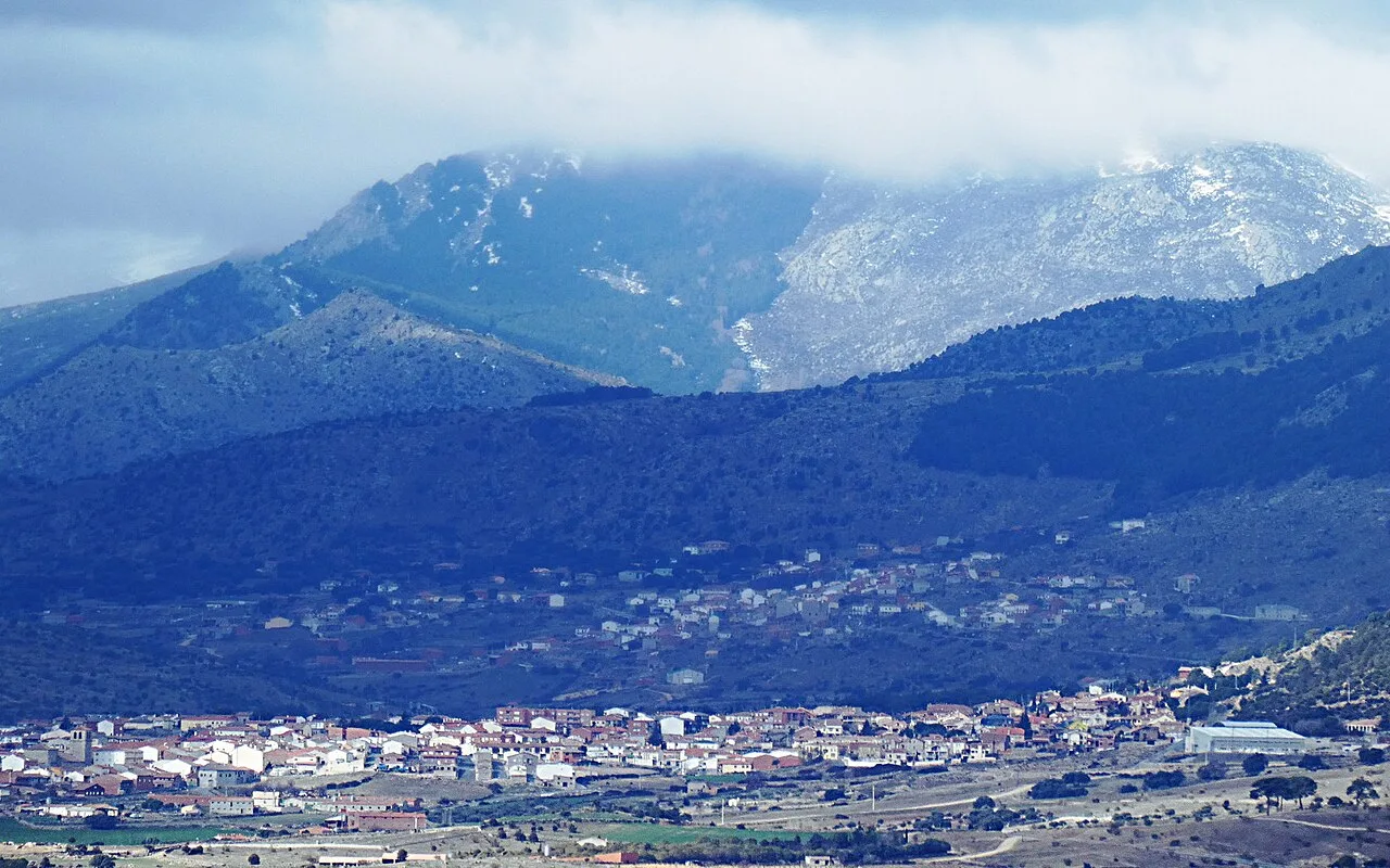 View of a town in a valley surrounded by mountains.