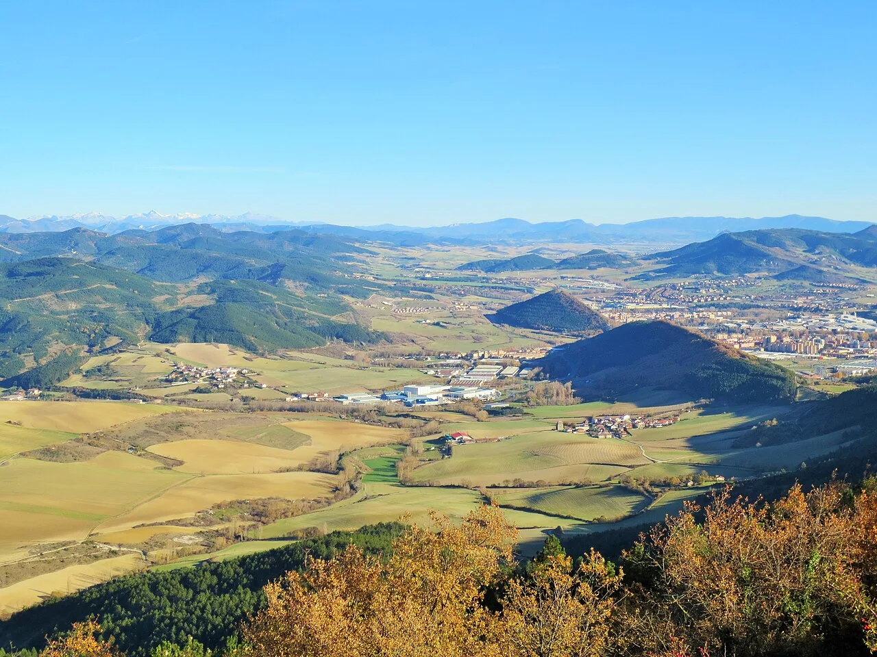 Ezkabarte valley and eastern fringes of Pamplona, Navarre, as seen from mount Ezkaba (San Cristobal), with the western and central Pyrenees far in the background