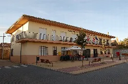 Town hall with balcony and flags in Manganeses de la Lampreana.