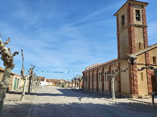 Square with church and bell tower in Juarros de Voltoya, Segovia.