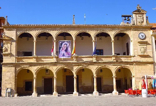 Facade of Villarrobledo town hall with arches and flags