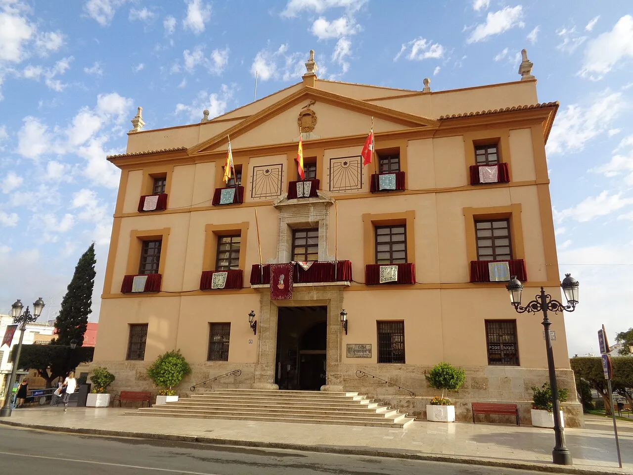 Building with flags and stairs at the entrance, town hall in Paterna.
