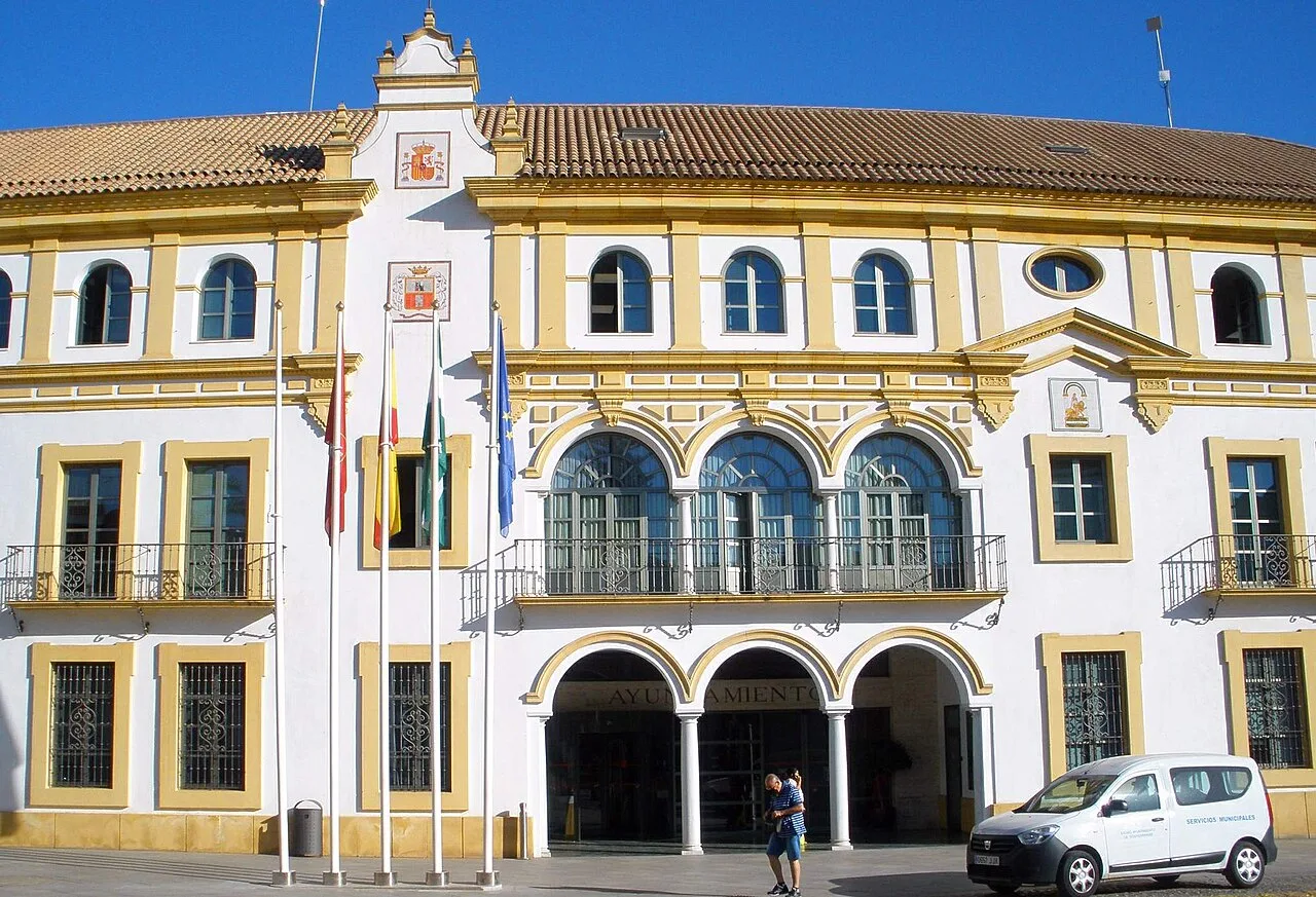 Town hall building with flags in the main square.