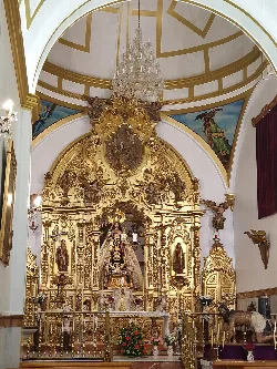 Golden religious altar with figures inside a church.