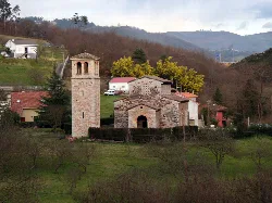 Stone church with tower in a rural landscape in Asturias.