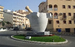 Large marble mortar sculpture in a roundabout in Macael.