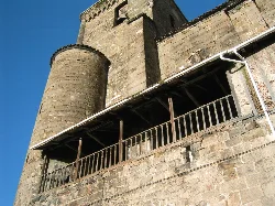 View of a tower and wooden balcony on a church in Isaba, Navarra.