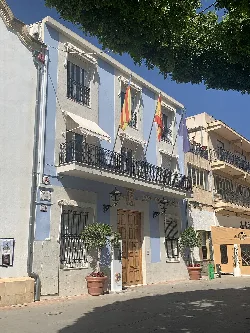 Cox town hall building with flags on the facade.