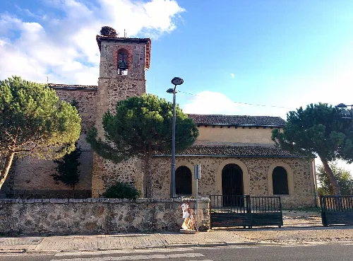 Church of the Assumption with tower and stone facade in Palazuelos de Eresma.