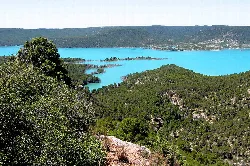 Contreras reservoir with blue water and green hills around.