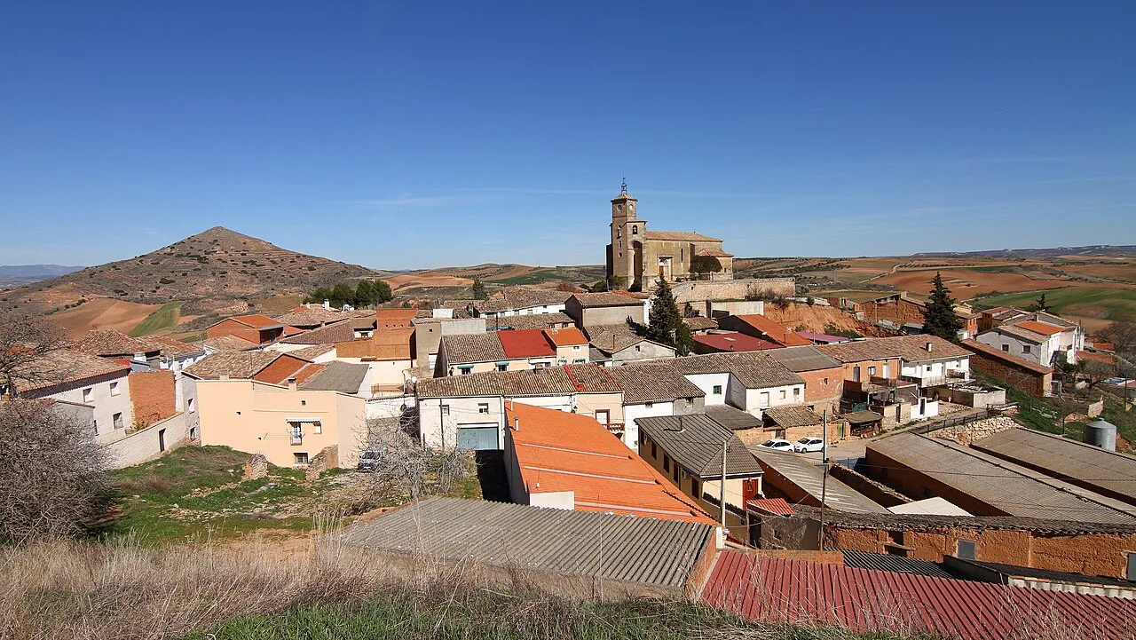 View of Alarilla with church and houses in a rural landscape.