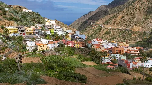 View of colorful houses on the slopes and mountains in Vallehermoso, La Gomera.