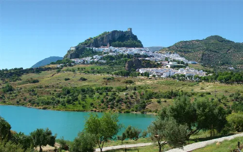 Landscape of Zahara de la Sierra with castle and white houses on the hills