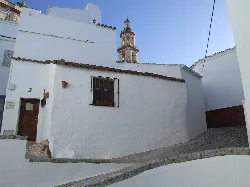 Cobblestone street with white houses in Olvera, Cádiz.