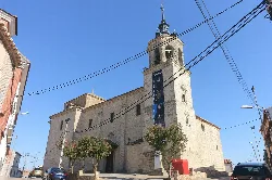 Stone church with tower and facade in Carmena, Toledo, Spain.