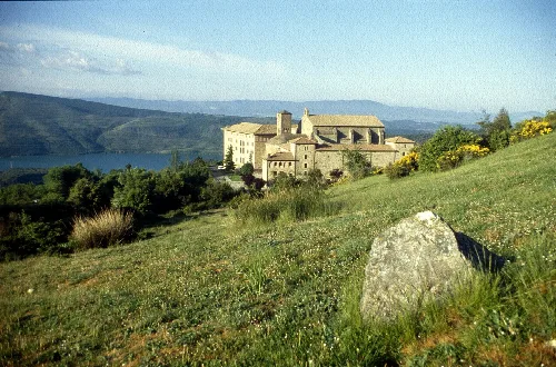 Monastery of Leyre in Navarra with meadows and lake in the background.