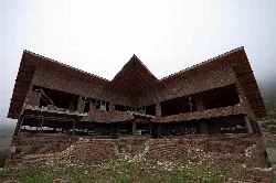 Wood and brick building on a mountain with V-shaped structure.