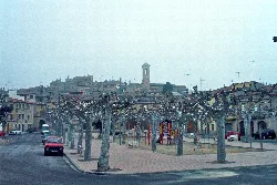 Square with trees, playground and old buildings in El Vilosell
