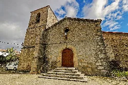Stone facade of San Lorenzo church with bell tower and steps.