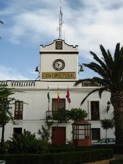 White building with clock and flags in Tarifa, Cádiz.