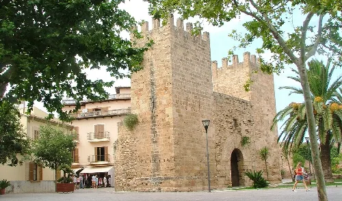 Stone gate with arch in Alcudia's city walls, Mallorca.