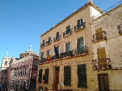 Classic style building with flags and iron balconies in Cuevas del Almanzora.