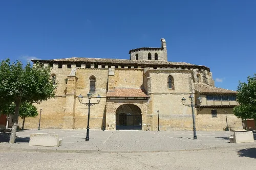 Stone facade and tower of the church in San Cebrián de Campos.
