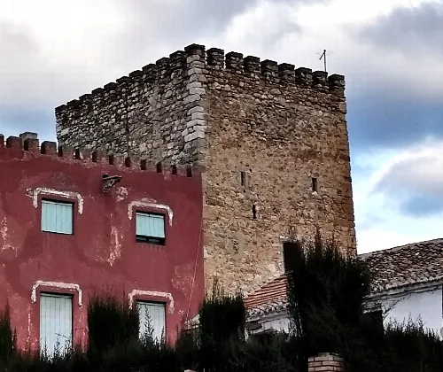 Steinturm in Salar, Granada, bei bewölktem Himmel.