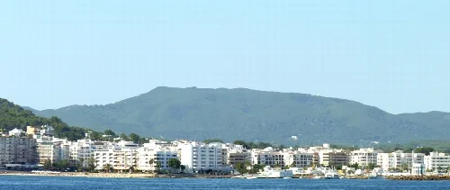 Panoramic view of Santa Eulària des Riu with buildings and mountains.