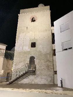 Tower with worn walls and modern staircase in Huétor Tájar.