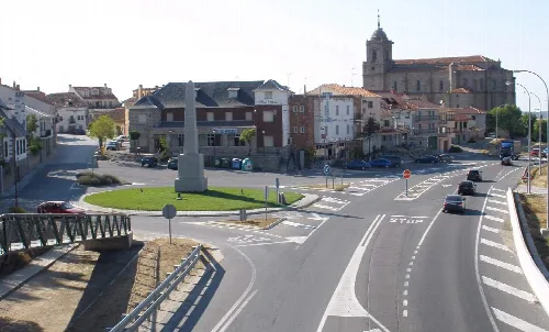 Square with monument and historic buildings in Villacastín, Segovia.