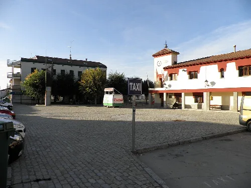 Hauptplatz von San Pedro del Arroyo mit Gebäuden und Uhrturm.