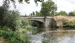 Stone bridge over the Pisuerga river in Melgar de Fernamental.