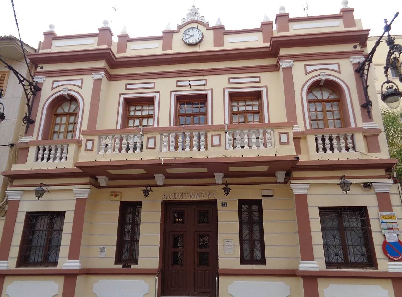 Facade of Puebla de Vallbona town hall with windows and balcony.