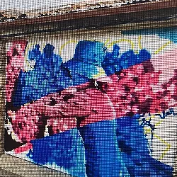 Mural with human figures in blue and pink colors on a street wall.