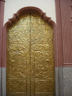 Golden door with ornate details at the Church of the Sang in Nules.