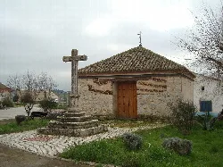 Small chapel with stone cross and gardens in Velliza.