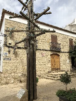 Stone facade of the museum with a wooden telephone pole in the foreground.