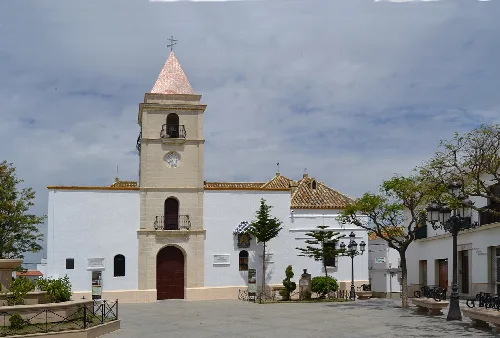Weiße Kirche mit Glockenturm und Uhr auf dem Platz der Verfassung.