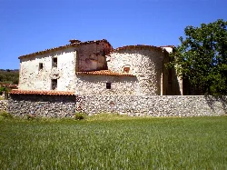 Hermitage of Collado in Berninches with stone walls and red tile roof.