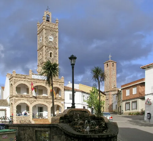 Town hall with clock and tower in La Nava de Ricomalillo.