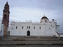 White sanctuary with dome and tower in Oliva de la Frontera