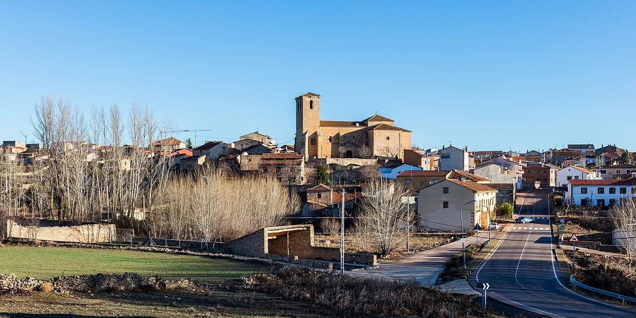 View of a village with church and houses on the hill in Guadalajara, Spain.