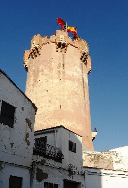 Paterna tower with flags at the top, viewed from below.