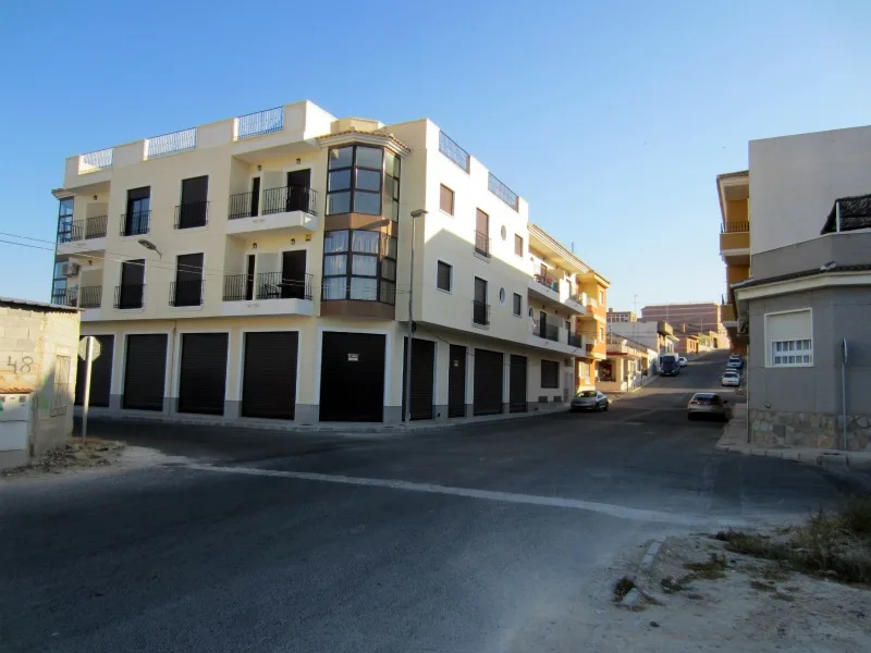 Apartment building with multiple floors and balconies in San Miguel de Salinas.
