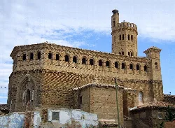 Iglesia de San Pedro Apóstol en Alagón con torre y fachada de piedra.