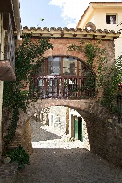 Piety hermitage in Cornago with arch and cobbled street below.