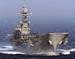 Aircraft carrier Principe de Asturias on the sea with planes on deck.
