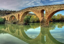 Stone bridge with arches over the Arga river in Puente la Reina.