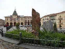 Main square of Bernardos with buildings and a slate monument.